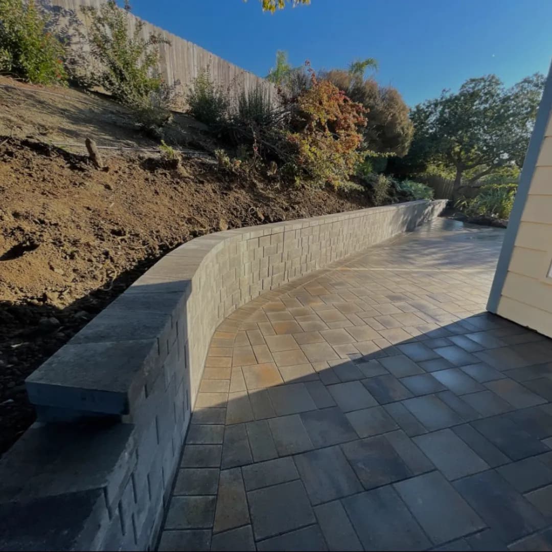Tiered retaining wall with landscaping and planting beds